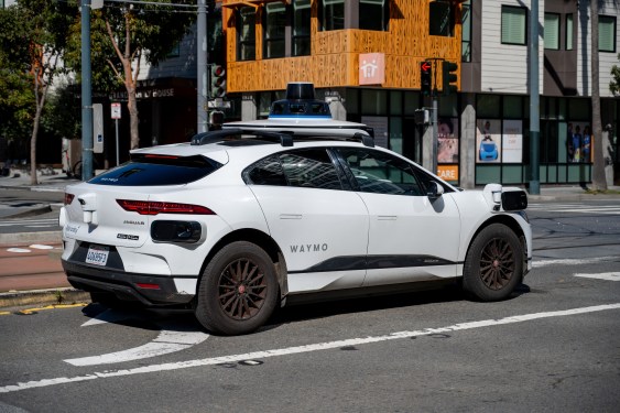 Waymo self driving car waiting at a city intersection in San Francisco